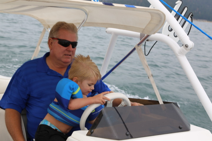 Ed helping a young child steer a boat