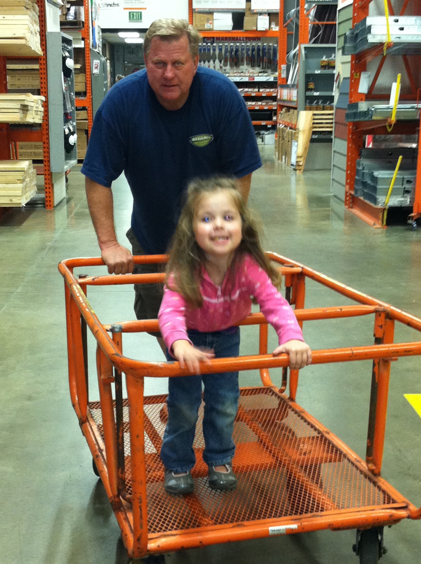 Ed sharing a playful shopping trip with his granddaughter